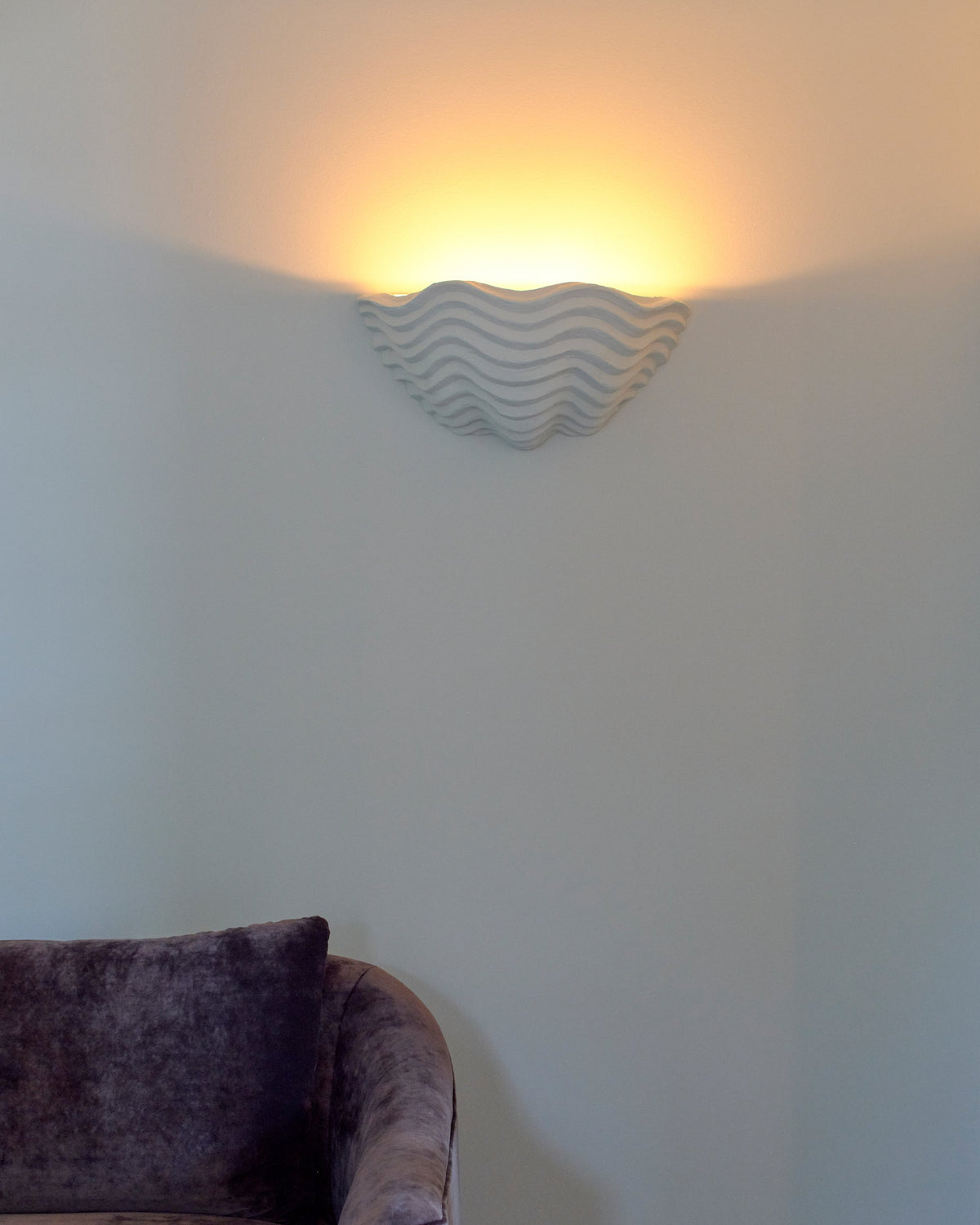 Clam Sconce, lifestyle interior view above sofa