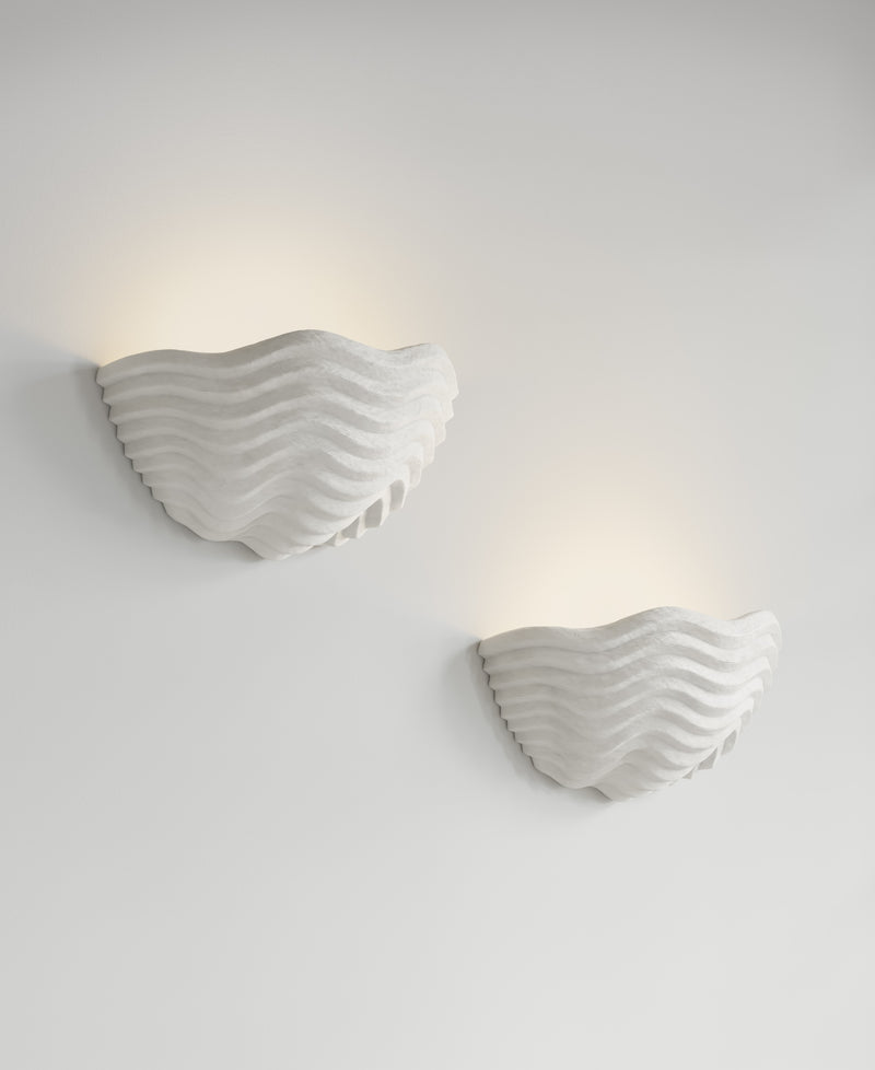 Clam Sconce paired installation, light-on view, two resin wall sconces