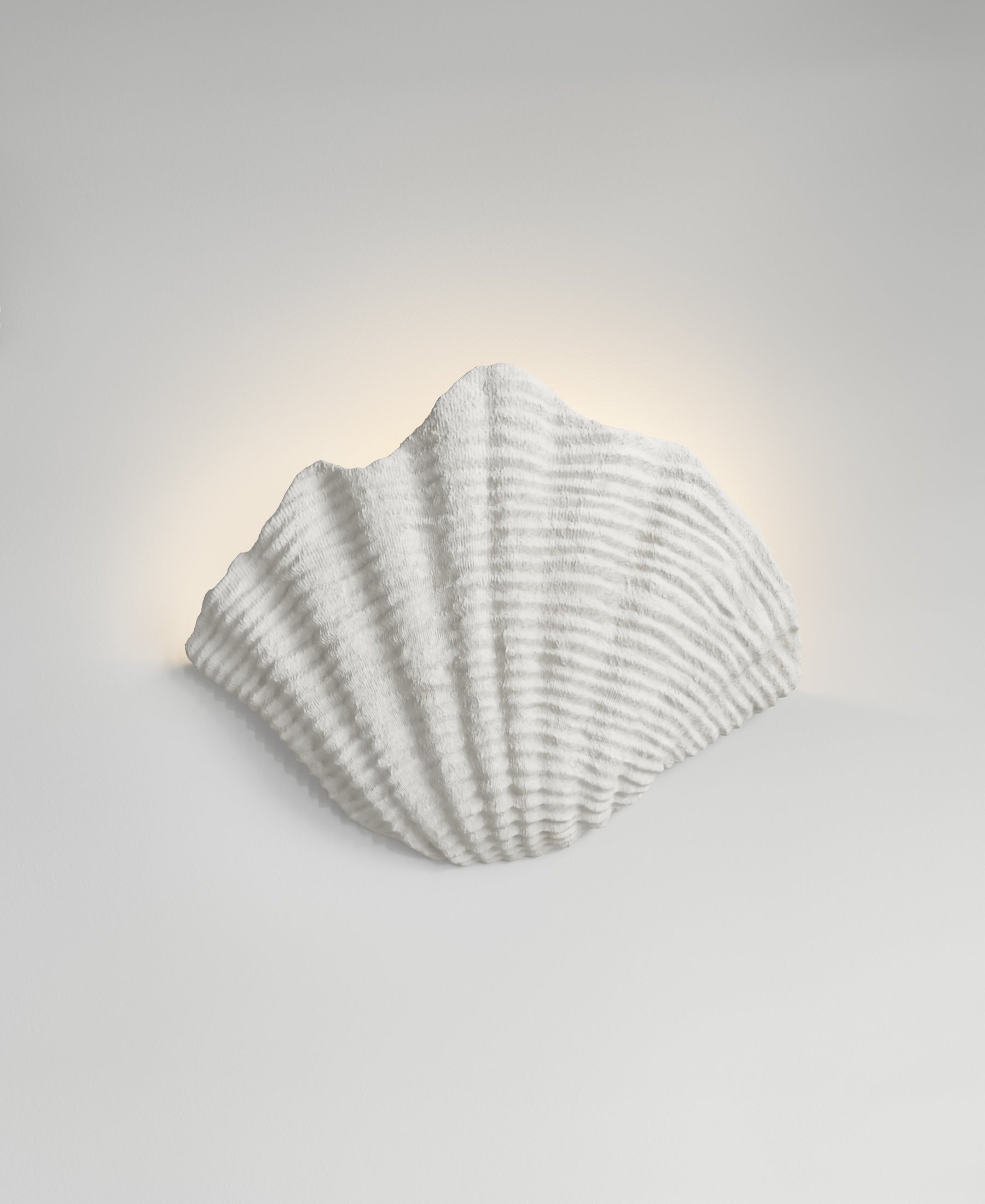 Cove Sconce, light-on view, resin wall sconce