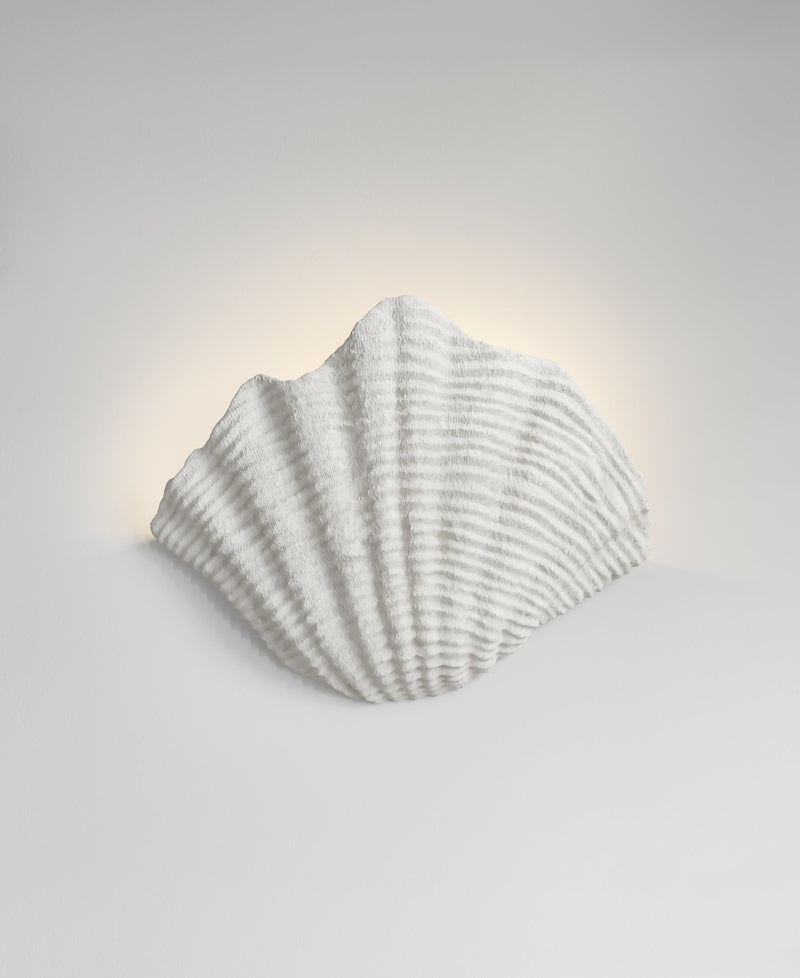 Cove Sconce, light-on view, resin wall sconce