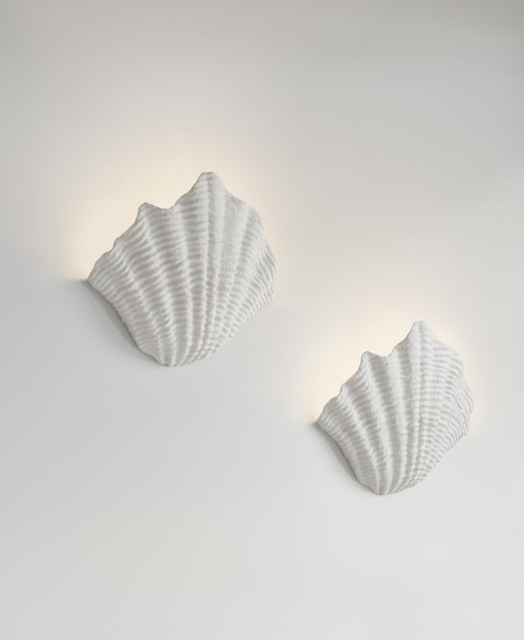 Cove Sconce paired installation, lit view, two resin wall sconces