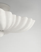 Moreau hanging light, close-up textured plaster surface