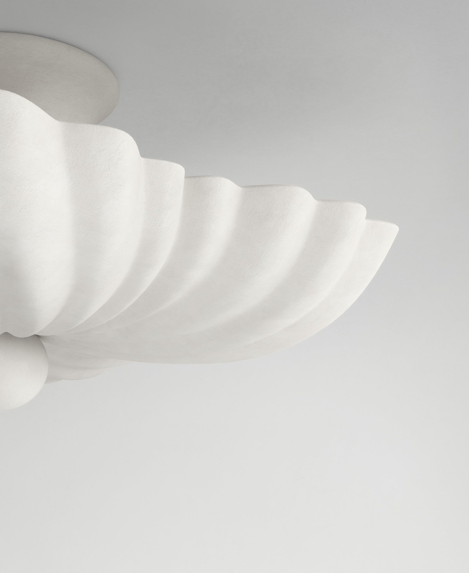 Moreau hanging light, close-up textured plaster surface