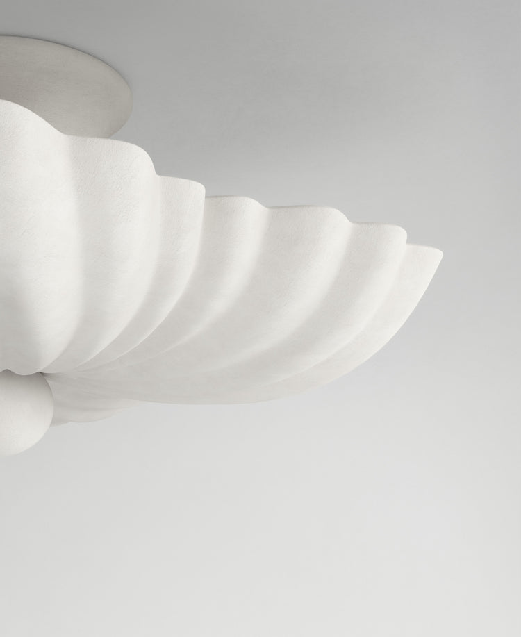 Moreau hanging light, close-up textured plaster surface