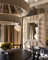 Albini Mirror, lifestyle view in interior, white sculptural plaster mirror