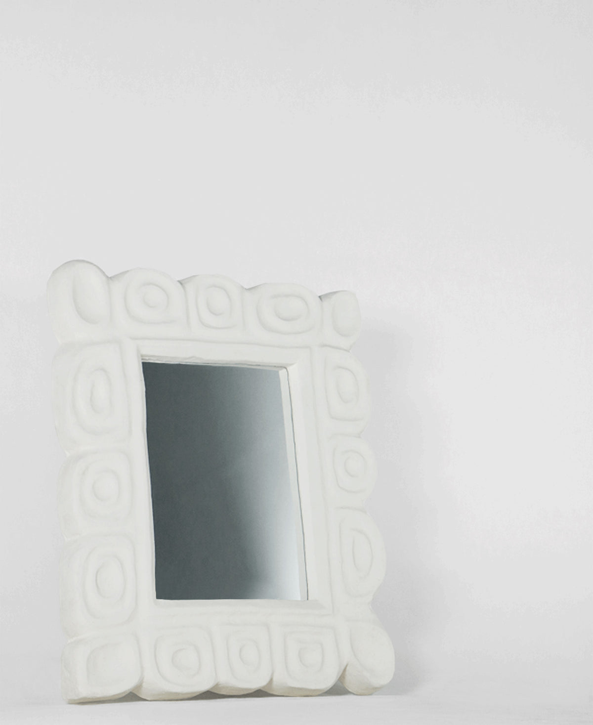 Cocteau Mirror, angled view, carved plaster wall mirror